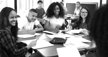 Group of high school students working on an assignment together