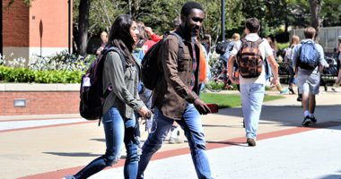 Students walking across a college campus