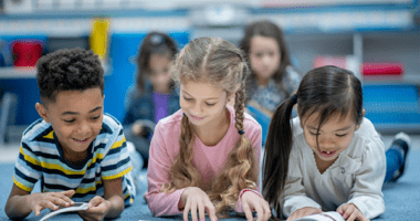 three young students reading books