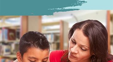 Teacher helping a student of color in library