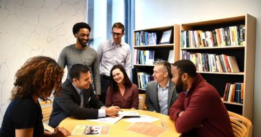 Group of higher education adults working together at a table