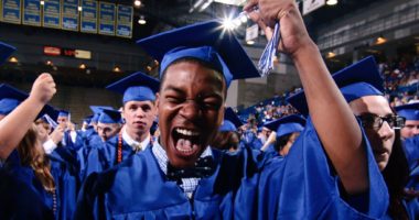 Graduation candidate celebrating while moving his tassel