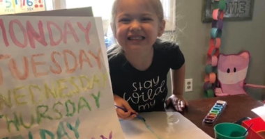 Little girl painting at home