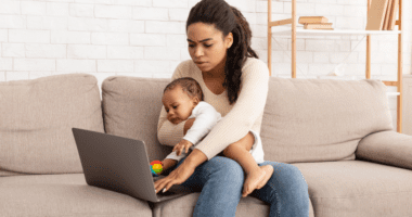 Parent with Child Trying to Work on a Laptop