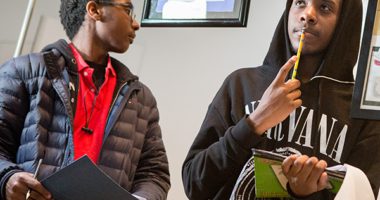 two male students standing in a school hallway